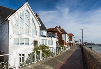 Exterior view of apartments alongside river bank
