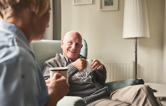 Residential patient talking with care home worker
