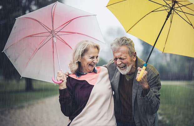 Couple walking with umbrellas