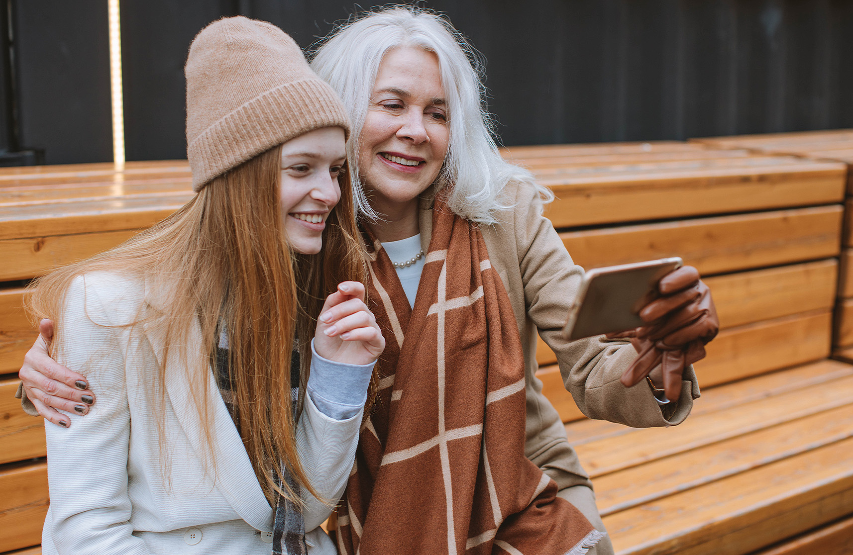 An image of a resident of Burnham Waters luxury retirement homes and a family member participating in activities over autumn. 