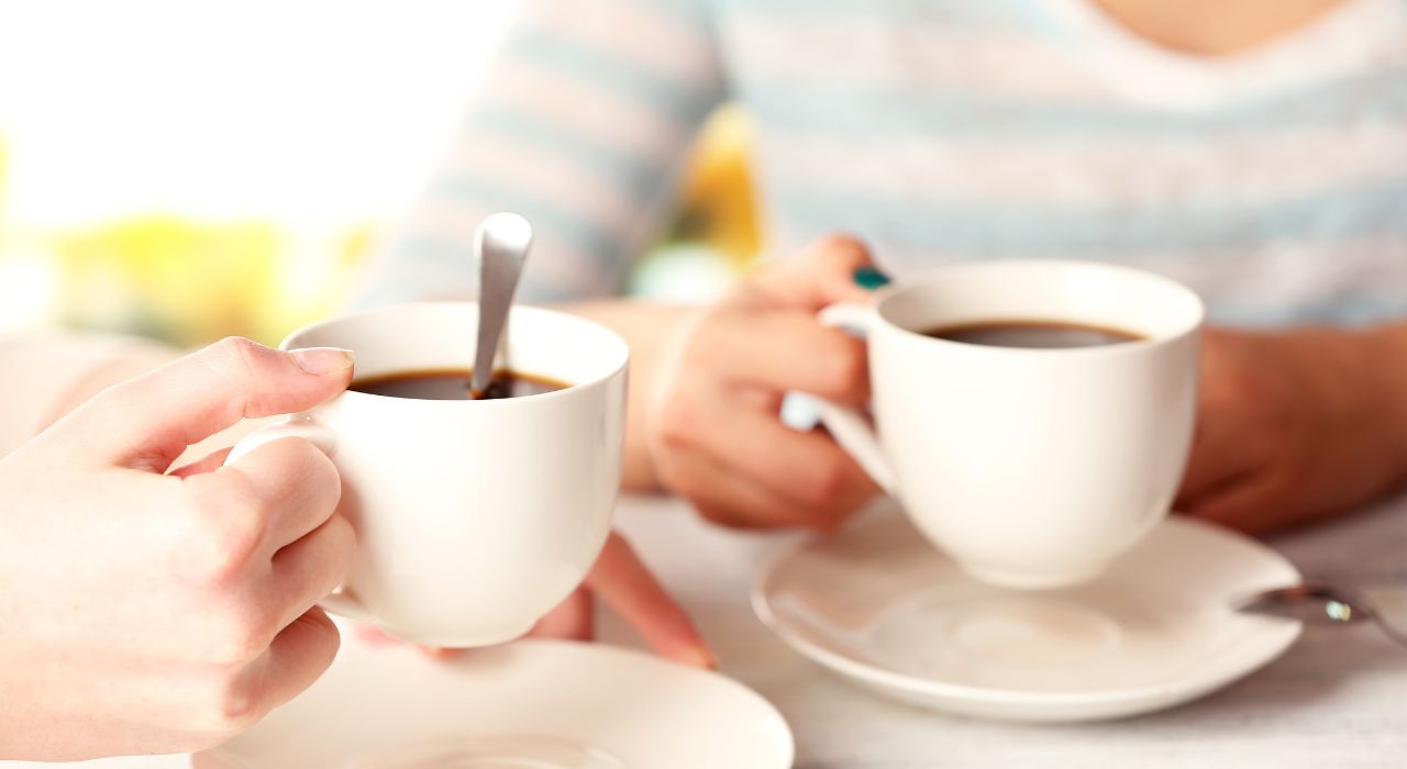 Burnham Waters retirement homes Essex - photo of two hands holding two cups of coffee