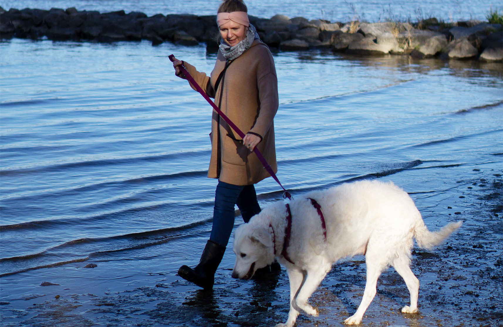 An image of a dog walker enjoying Burnham on Crouch in Essex villages to visit.