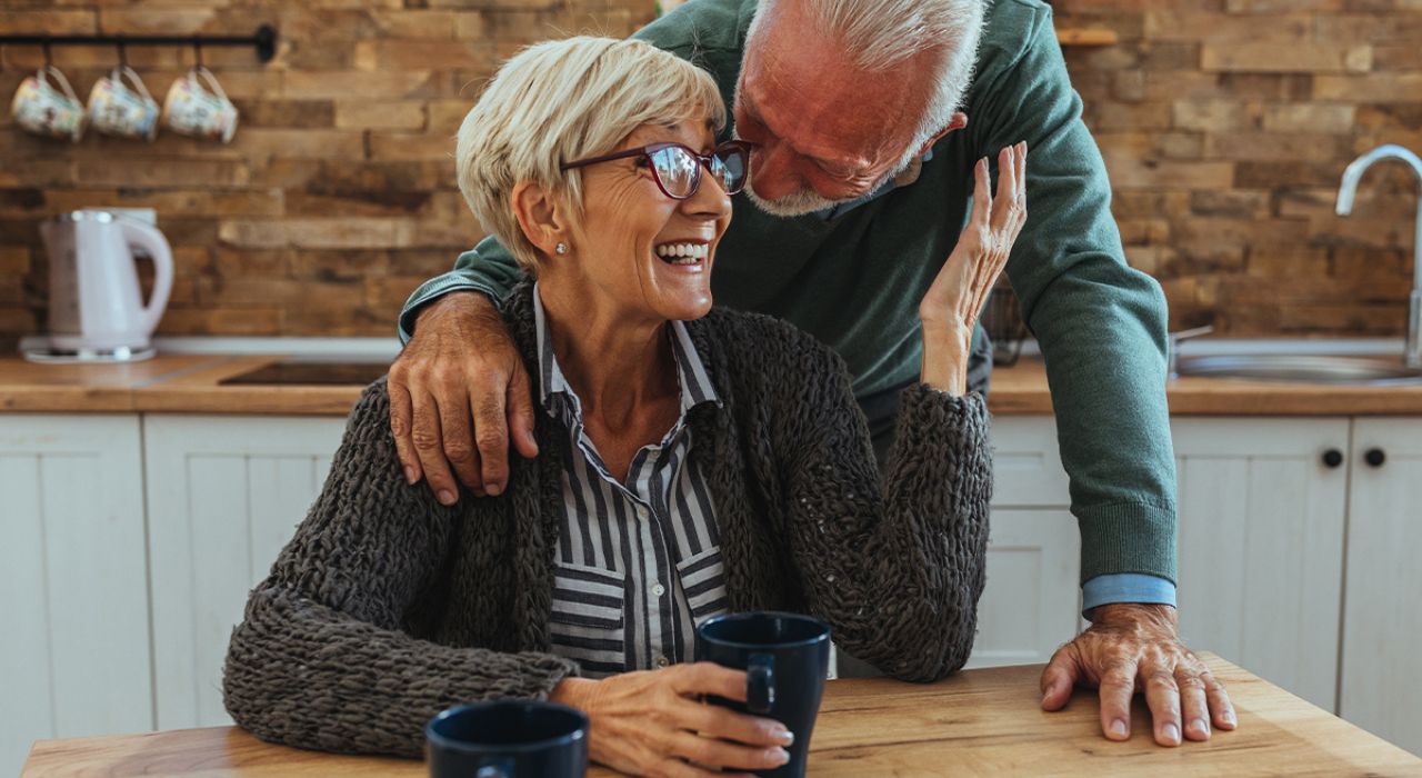Stamp duty incentive at Burnham Waters_older couple smiling together at table