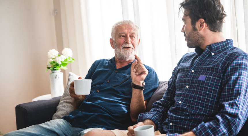 Father and son sat on sofa celebrating Father's Day in Essex 2026