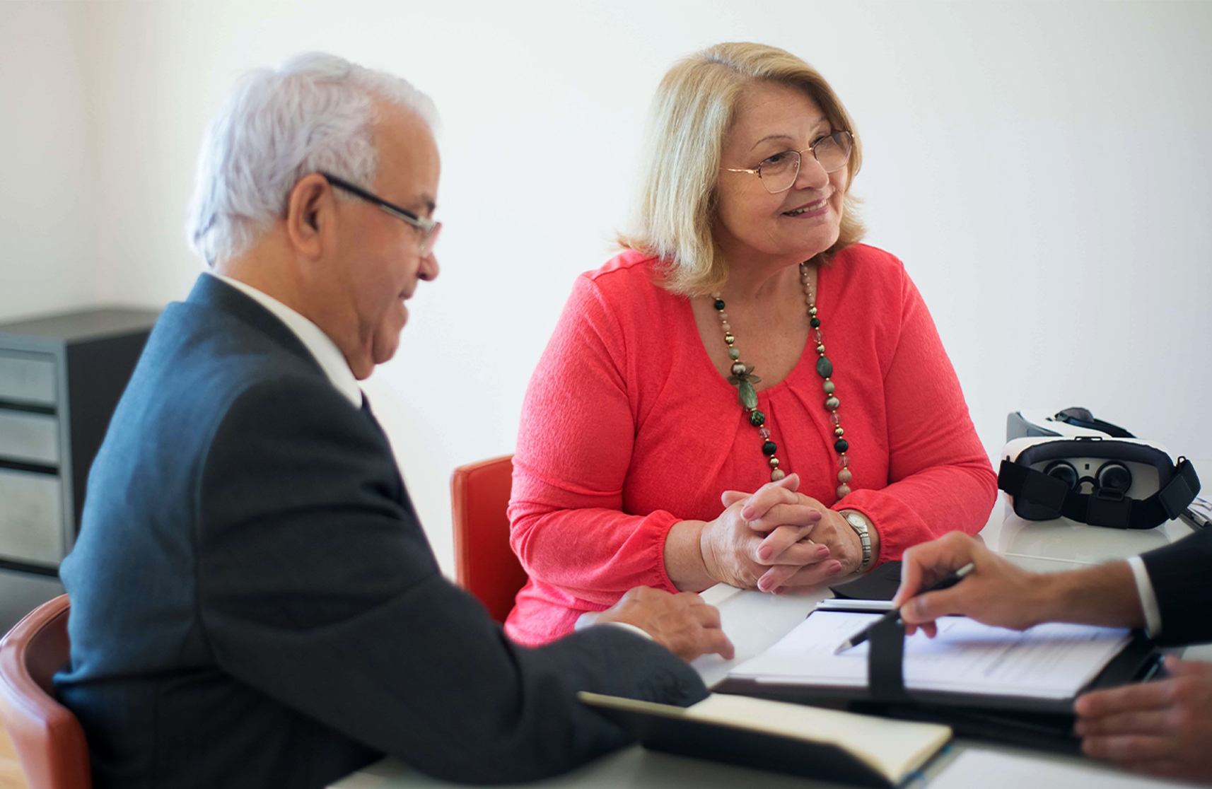 An image of an elderly couple enquiring about houses for over 55’s.