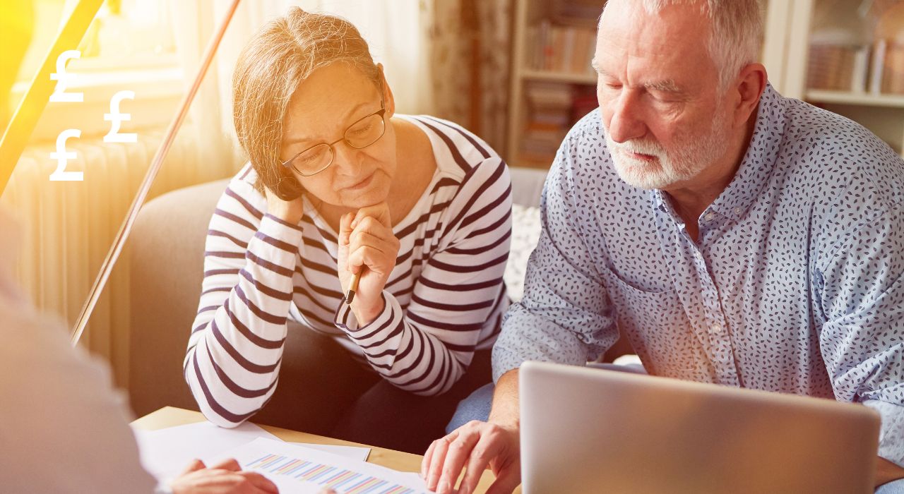 How much do i need to retire, older couple sat looking at laptop and paperwork