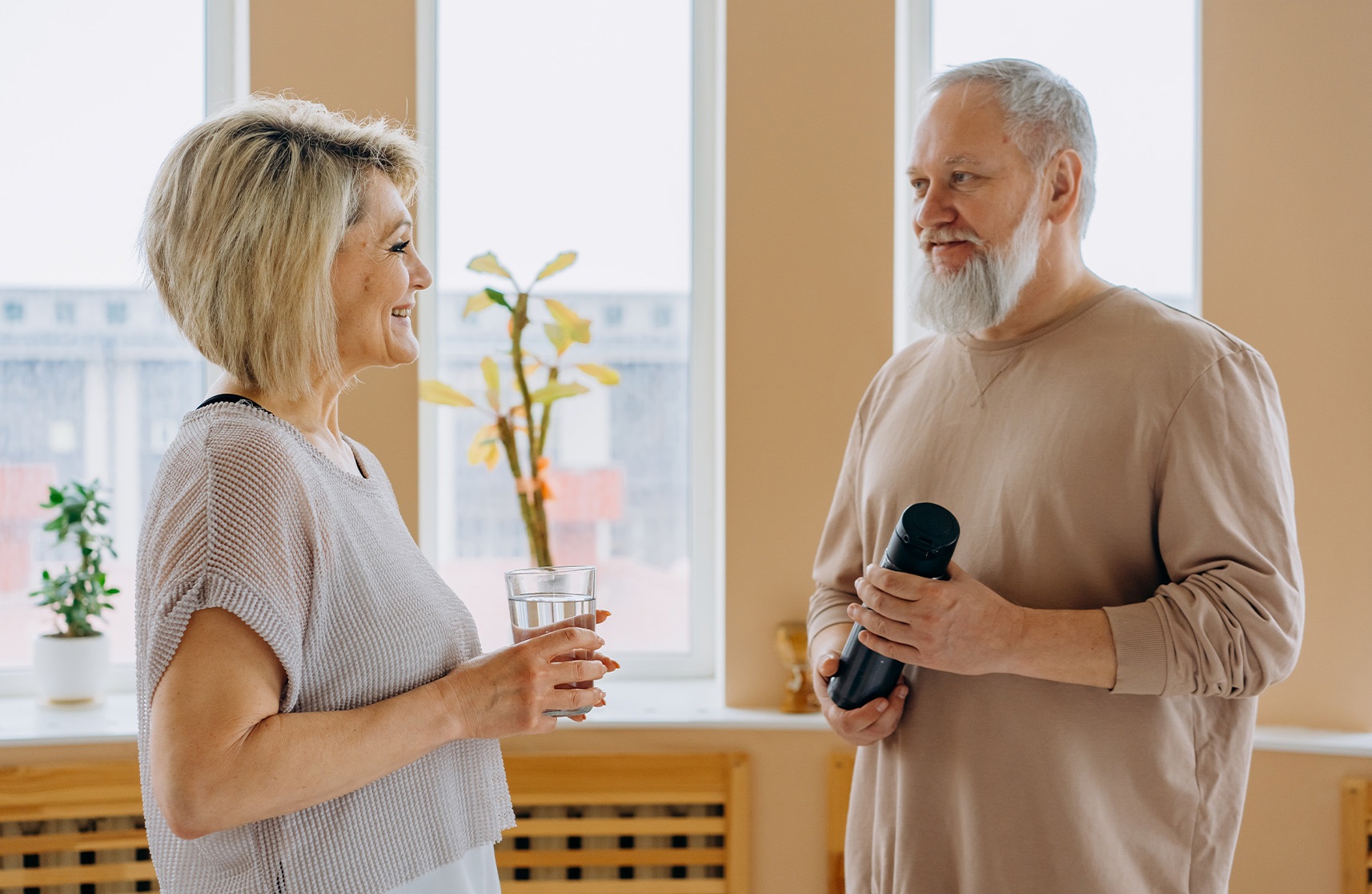 An image of two older residents enjoying a chat after exercise classes in lifestyle retirement villages.