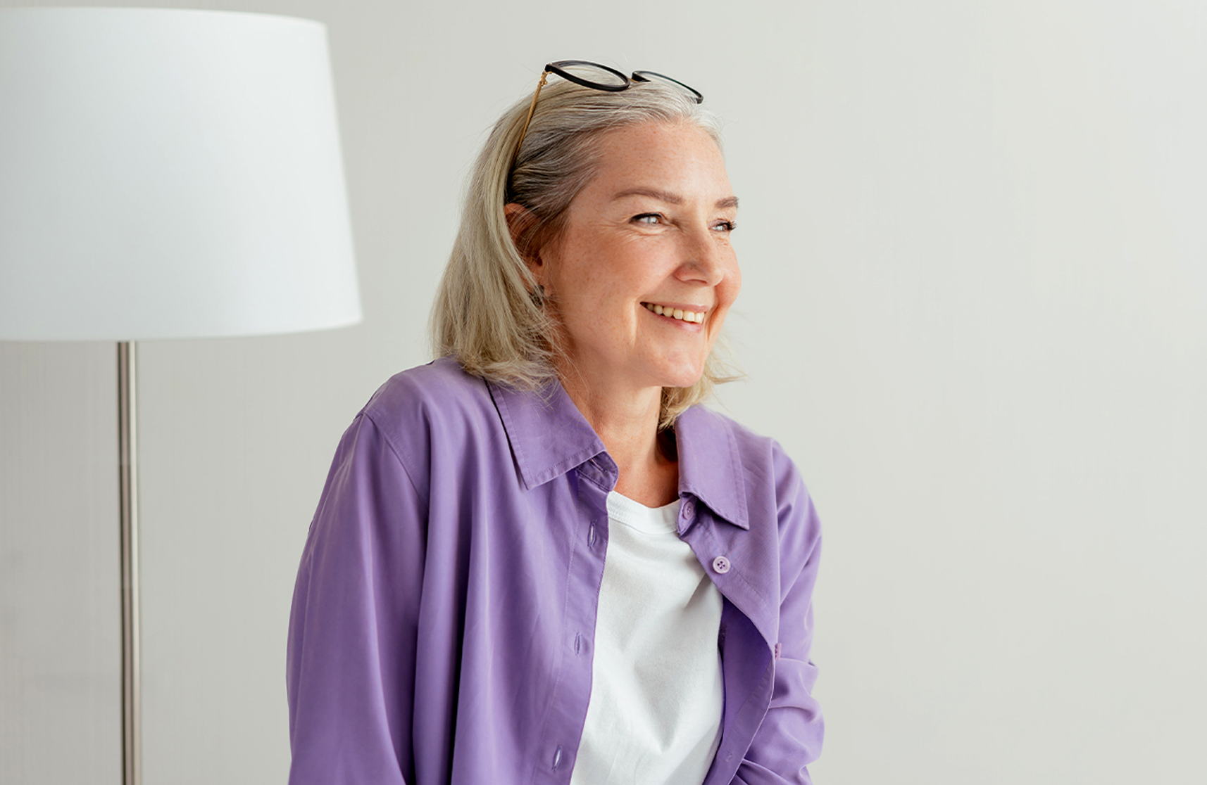 An image of a middle aged lady smiling to represent a happy retirement in an over–55s community near me.
