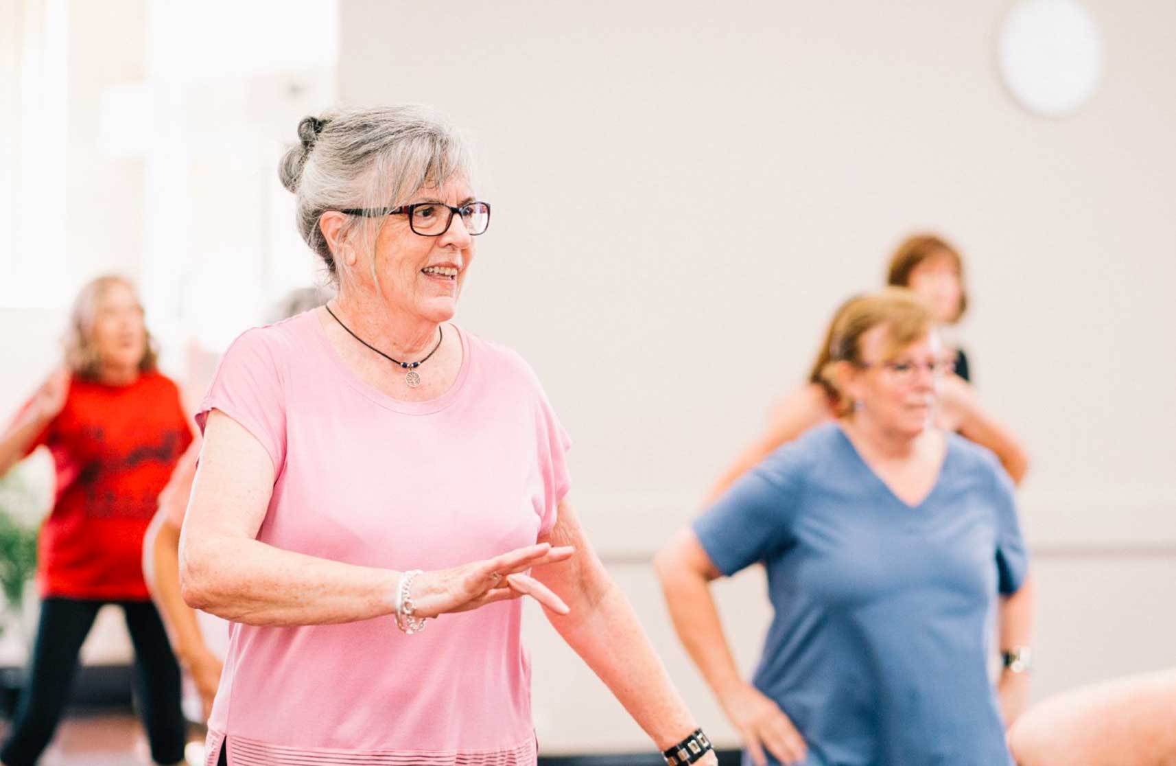 An image of residents exercising at a class to demonstrate the benefits of independent living in our retirement apartments to buy in Essex