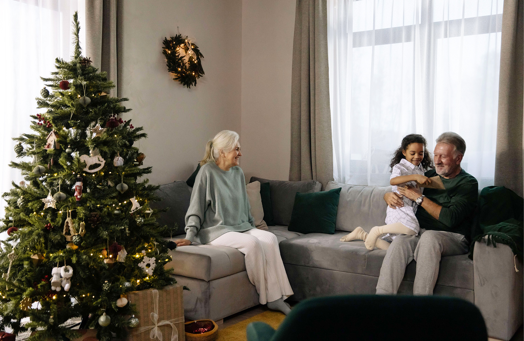 An image of an elderly couple with their grandchild in UK retirement villages, to represent things to enjoy December.  