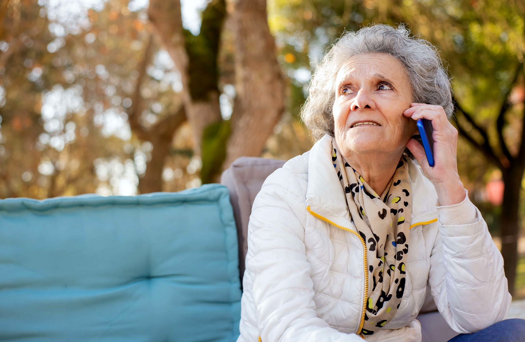 An image of an elderly resident talking to someone on the phone to represent the importance of mental health outlets for those aged 55 and over.