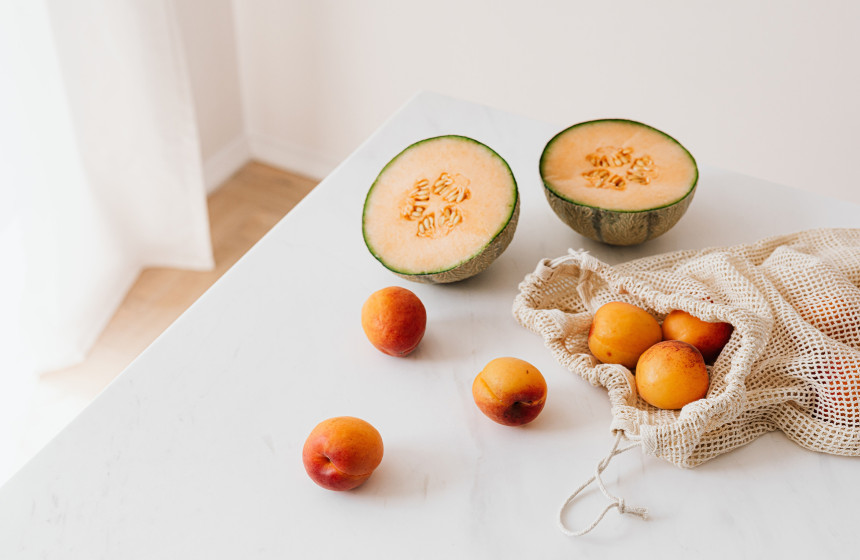 An image of a reusable material bag and local fruit produce to represent sustainability in new build retirement homes.