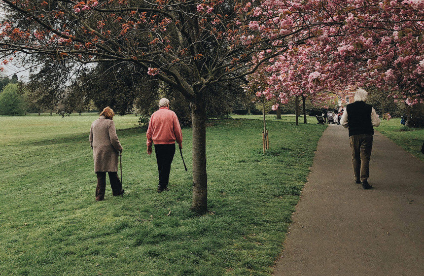 An image of an older couple walking in the park to represent Essex villages to visit.