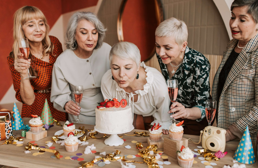 An image of a resident at their 60th birthday party to represent the importance of socialisation in luxury retirement communities.