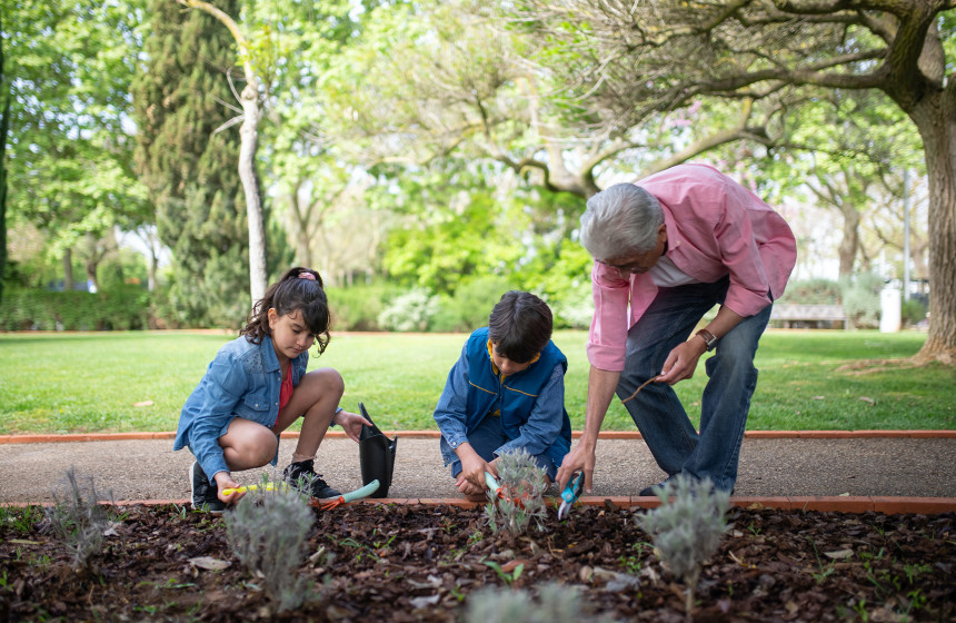 An image of a resident at one of the retirement villages in Essex gardening on Earth day with their grandchildren.