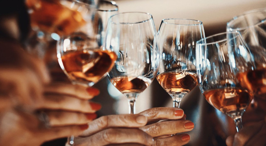 Senior living in Essex - wine tasting event Burnham Waters - hands holding wine glasses