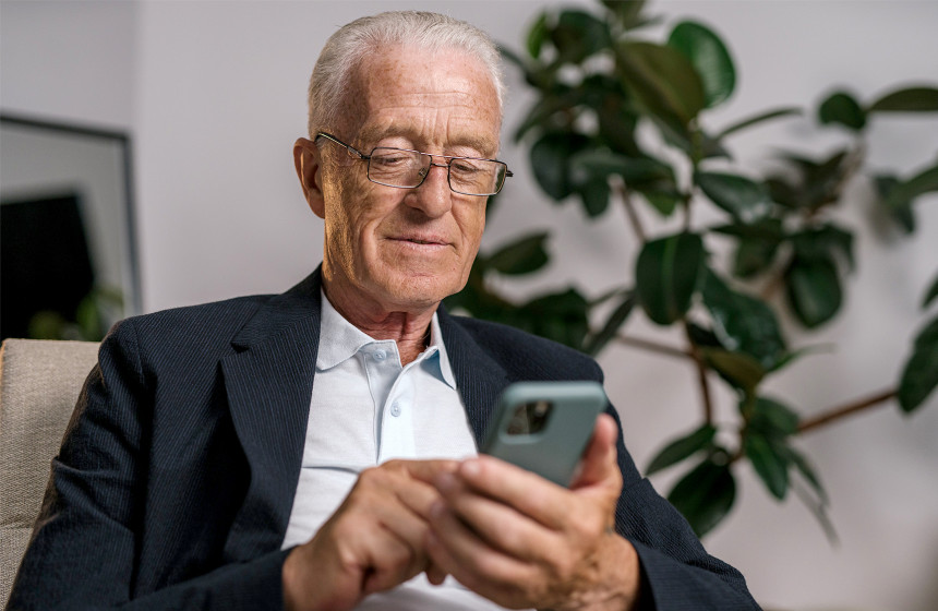 An image of a resident using their phone to represent the top apps for 55 and overs. 
