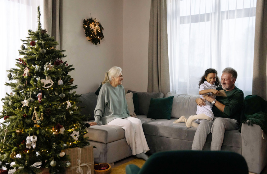 An image of an elderly couple with their grandchild in UK retirement villages, to represent things to enjoy December.