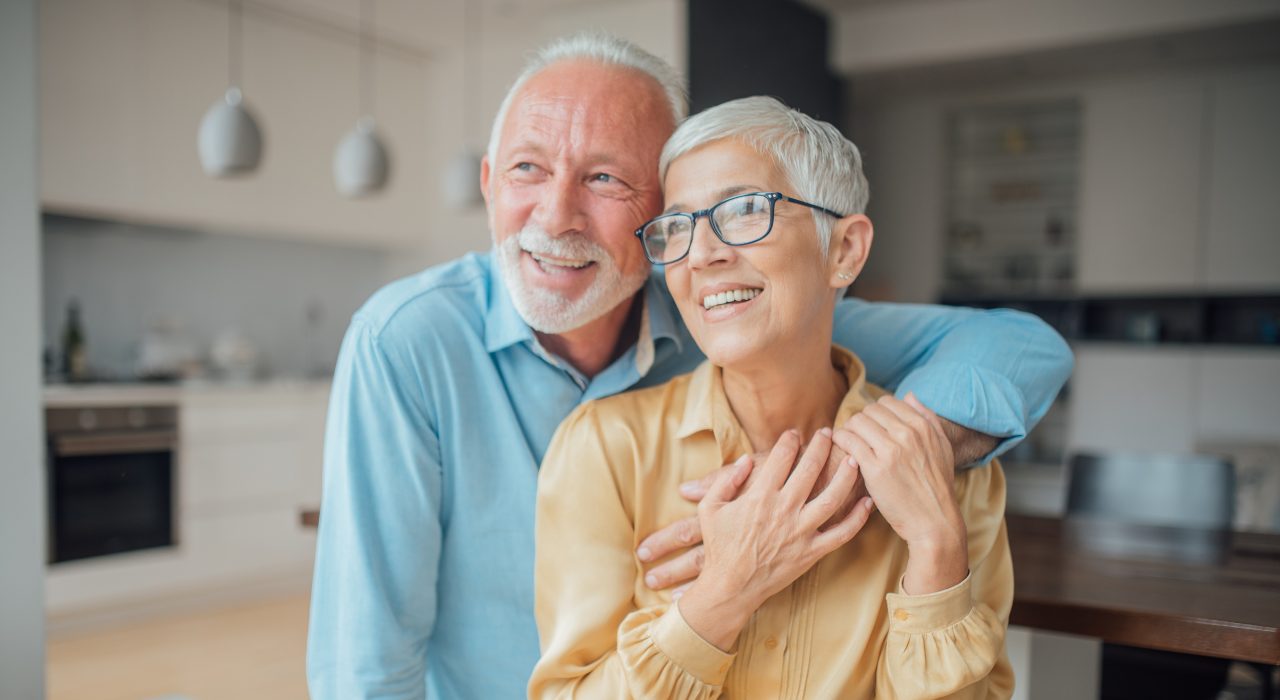 New homes sales incentive at Burnham Waters - older couple stood in kitchen smiling