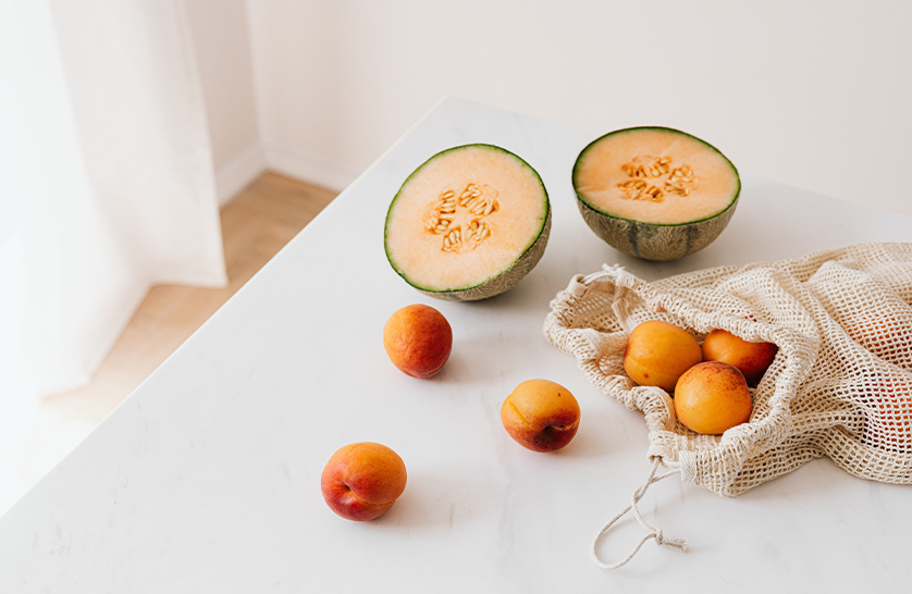 An image of a reusable material bag and local fruit produce to represent sustainability in new build retirement homes.