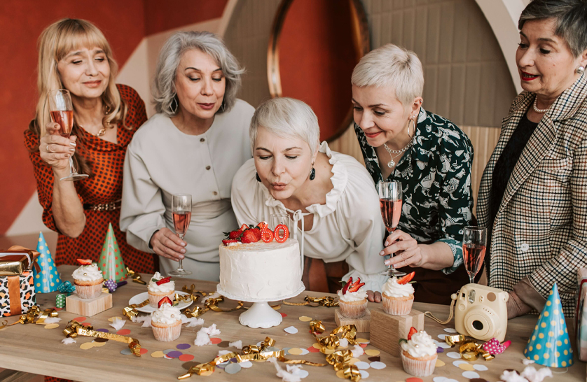 An image of a resident at their 60th birthday party to represent the importance of socialisation in luxury retirement communities.