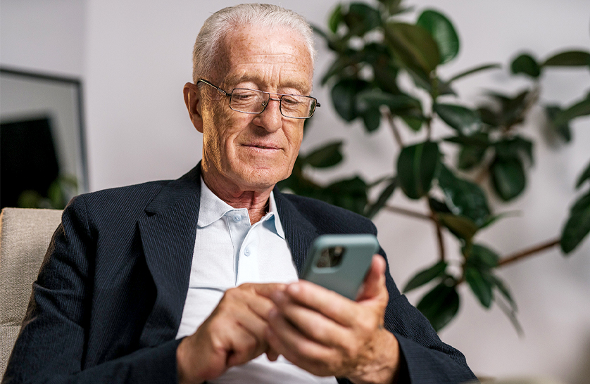 An image of a resident using their phone to represent the top apps for 55 and overs. 