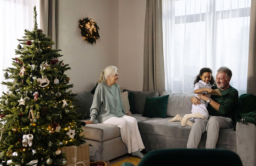 An image of an elderly couple with their grandchild in UK retirement villages, to represent things to enjoy December.