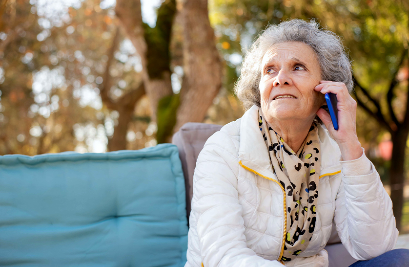 An image of an elderly resident talking to someone on the phone to represent the importance of mental health outlets for those aged 55 and over.