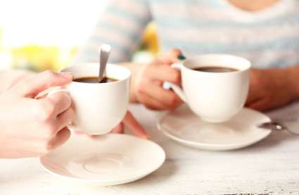 Burnham Waters retirement homes Essex - photo of two hands holding two cups of coffee