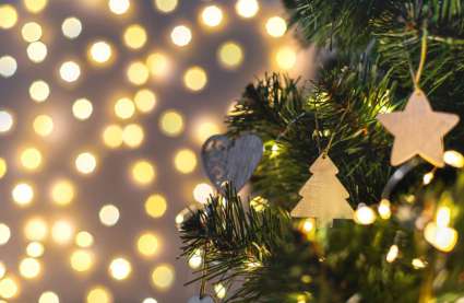 Christmas things going on near me 2025 in Essex. Christmas tree with decorations and twinkling lights behind.