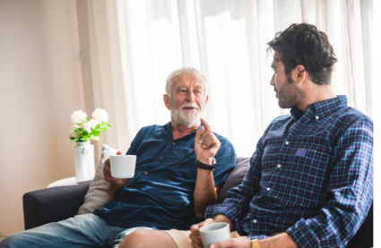 Father and son sat on sofa celebrating Father's Day in Essex 2026