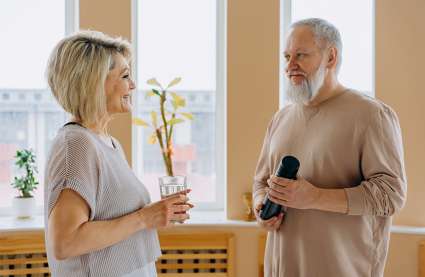 An image of two older residents enjoying a chat after exercise classes in lifestyle retirement villages.