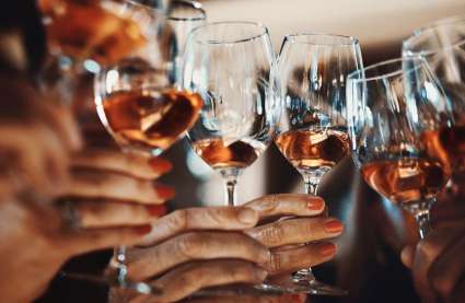 Senior living in Essex - wine tasting event Burnham Waters - hands holding wine glasses